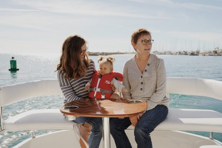 a person sitting at a table in front of a body of water